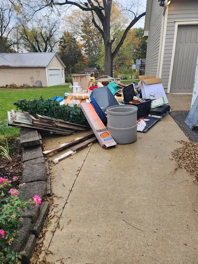 Dumpster being loaded with debris for Demolition Dumpster Rental in Edgerton